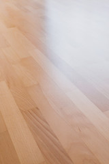 Smooth glare varnished parquet lit from the window