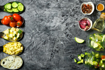 Vegetables on the background. Fresh vegetables (cucumbers, tomatoes, onions, garlic, dill, green beans) on a gray background. Top view. Copy space