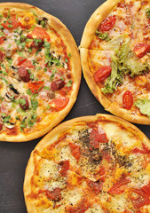 Delicious pizza on dark board.