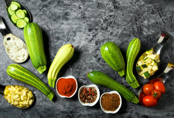 Vegetables on the background. Fresh vegetables (cucumbers, tomatoes, onions, garlic, dill, green beans) on a gray background. Top view. Copy space