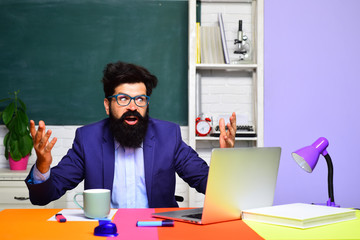 Educational process. Male student learning in classroom. Teacher. Education, knowledge concept. Coffee break. Back to school. Student thinking about coursework. Surprised male student in auditorium.