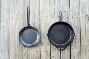 Traditional cast iron vs carbon steel versus teflon cooking options - copy space