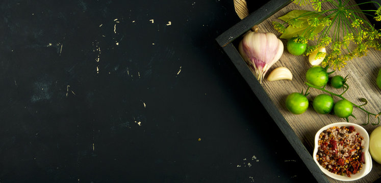TEXTURE OF VEGETABLES IN A BOX ON A DARK BACKGROUND. CONCEPT OF PREPARING VEGETABLES FOR WINTER.