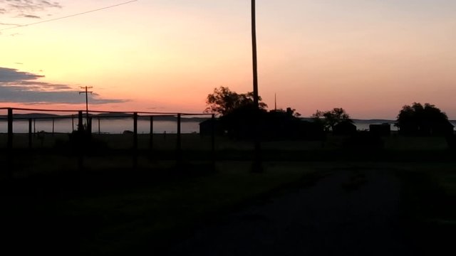 View on the country side in the morning before the sun comes up in Alberta Canada with a view of mountains and fog.