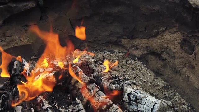 Close view at glowing charcoal and flame in barbecue grill