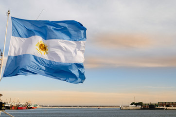Argentine flag flying in the port of Mar del Plata. ARA San Juan submarine in the background.