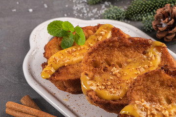 Traditional Christmas Rabanadas with egg yolk crea and cinnamon. Spanish Torrijas close up on the countertop.
