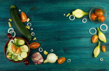 VEGETABLES ON BACKGROUND. FRESH VEGETABLES AND SPICES ON A WOODEN SURFACE. COPY SPACE