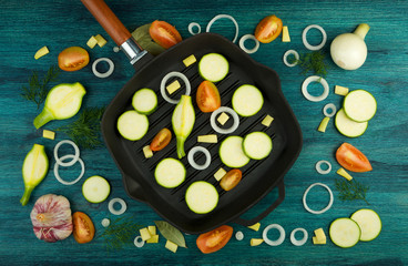 VEGETABLES ON BACKGROUND. FRESH VEGETABLES AND SPICES NEAR A FISHING SET ON A WOODEN SURFACE. COPY SPACE