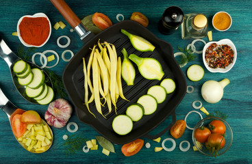 VEGETABLES ON BACKGROUND. FRESH VEGETABLES AND SPICES NEAR A FISHING SET ON A WOODEN SURFACE. COPY SPACE