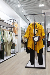 Interior of clothing store .Bright interior.Minimalistic style.Trendy colors.Yellow coat