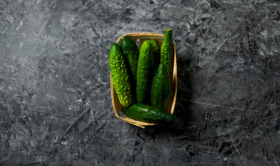 Vegetables on the background. Fresh vegetables (cucumbers, tomatoes, onions, garlic, dill, green beans) on a gray background. Top view. Copy space