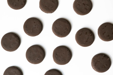 Group of thin mints cookies on white background, chocolate mint thin round cookies, top view