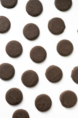 Group of thin mints cookies on white background, chocolate mint thin round cookies, top view