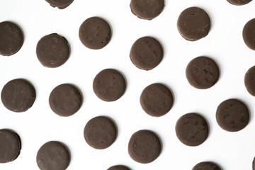 Group of thin mints cookies on white background, chocolate mint thin round cookies, top view