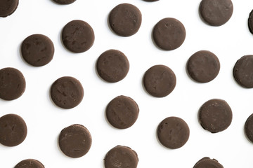Group of thin mints cookies on white background, chocolate mint thin round cookies, top view