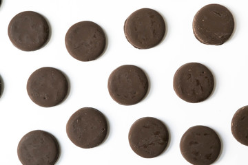 Group of thin mints cookies on white background, chocolate mint thin round cookies, top view