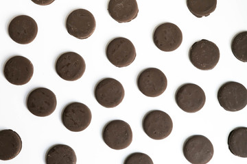 Group of thin mints cookies on white background, chocolate mint thin round cookies, top view