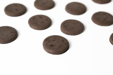 Group of thin mints cookies on white background, chocolate mint thin round cookies, top view