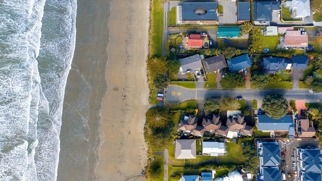 Aerial View from Houses close to the Beach, Green Trees and Cliff of Orewa in New Zealand - Auckland Area
