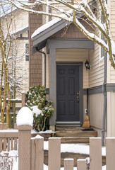 Fototapeta na wymiar Entrance door of residential townhouse on winter time.