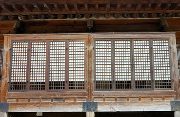 Part of the facade with a closed window of an ancient Korean palace building. Deoksugung Palace, Seoul.