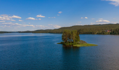 Small island on the Storån-Österdalälven lake in Idre, Sweden. Drone shot, july 2019