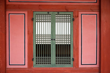 Part of the facade with a closed window of an ancient Korean palace building. Deoksugung Palace, Seoul.