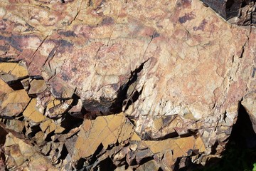 Rough rock surface with irregular jagged texture abstract horizontal background texture