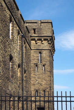 an abandoned victorian british stone institutional building surrounded by a fence typical of 19th century military and prison architecture formerly the wellesley barracks on gibbet lane in halifax