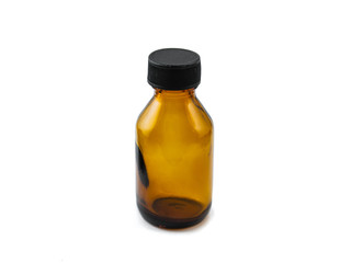 Amber semi-inclined small pharmaceutical empty glass bottle with black cap for mock-up or aromatherapy on white background