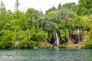 Beautiful Plitvice Lakes National Park in Croatia during the summer. Waterfalls and lakes complete this lush wonderland.