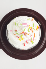 a cup cake with multi colors rice cocholate