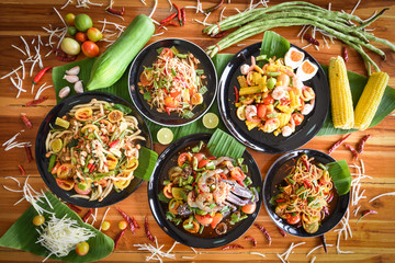 Papaya salad served on dining table - Green papaya salad spicy thai food on plate with fresh vegetables corn herbs and spices seafood shrimp crab noodles salted egg - Som tum Thai menu Asian food