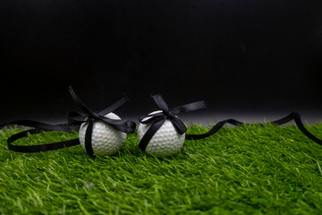 Golf ball with black ribbon for sad concept for golfer