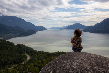 Adventurous Girl Hiking up a mountain during a vibrant summer day. Taken in Murrin Park near Squamish, North of Vancouver, BC, Canada.