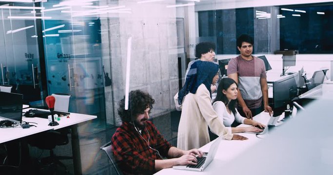 Young multiethnic business team of software developers working together using