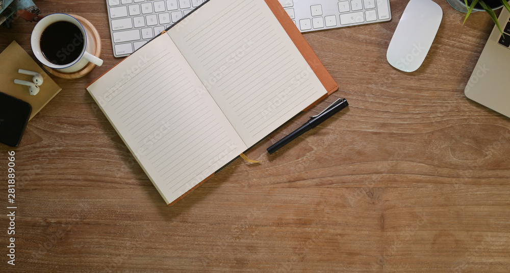 Aufkleber blank open notebook in comfortable workplace with office
