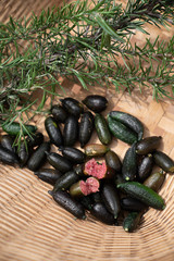 Fresh fingerlime in basket in natural light scene / farm concept / close up tree