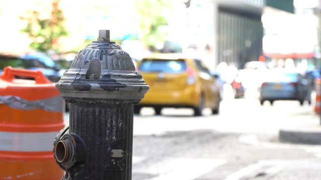Manhattan traffic and daily commute background video, featuring NYC key elements such as working people, tourists, roadwork and fire hydrant along with yellow cabs and other traffic in one shot