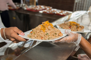 Delicious rice with seafood delivered to a diner in a restaurant bar.