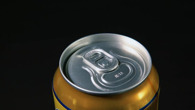 Man hand opening soda or beer can. Close up of can pull tab opening.