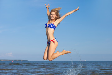 young happy girl in bikini at sea