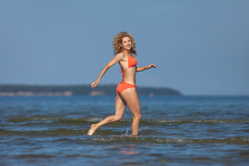 young happy girl in bikini at sea