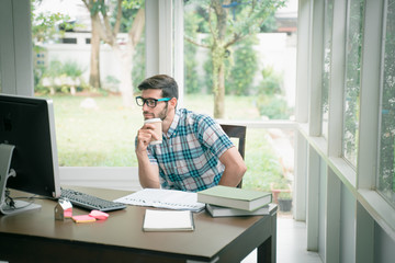 Fototapeta na wymiar success concept. Young modern businessman relaxing with computer while sitting in the office. The successful business analysis, creative design to analyze the management of the investment.