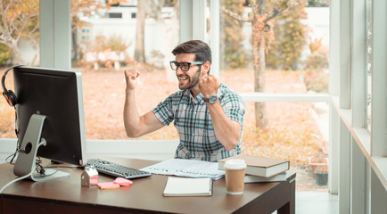 Fototapeta premium work from home concept. Young modern businessman relaxing with notebook while sitting in the office. The successful business analysis, creative design to analyze the management of the investment. 