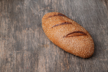 Freshly baked tasty bread on a wooden surface