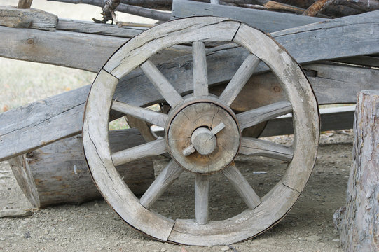 old (vintage) wooden wheel. 19th century wagon wooden wheel. antique metal parts made in the forge