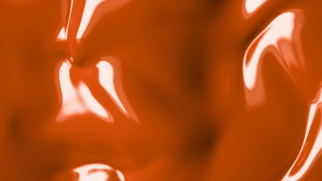 Super slow motion of mixing orange paint. Abstract background. Filmed on high speed cinema camera, 1000 fps.