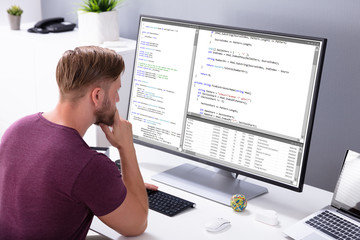 Man Programming Code On Computer